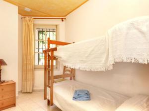 a bedroom with two bunk beds and a window at Apartment La Rectoria II by Interhome in La Vall de Santa Creu
