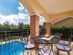 a patio with a table and chairs next to a pool at Holiday Home Lara by Interhome in Vrsar