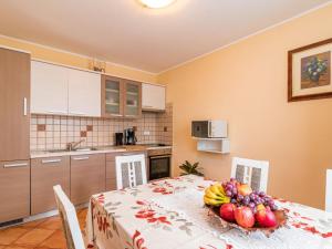 a kitchen with a table with a bowl of fruit on it at Holiday Home Lara by Interhome in Vrsar
