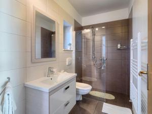een badkamer met een wastafel, een toilet en een douche bij Holiday Home Paula - ROJ440 by Interhome in Pazin