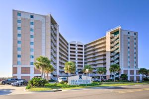 a large building with a sign in a parking lot at Sunny Beachfront Biloxi Condo with Resort Amenities! in Biloxi