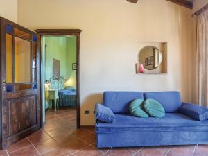 Sofá azul en la sala de estar con espejo en Holiday Home Del Regolo by Interhome en Molazzana