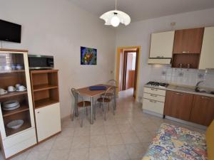 a kitchen with a table and chairs in a room at Apartment Doria Uno by Interhome in Lido degli Estensi