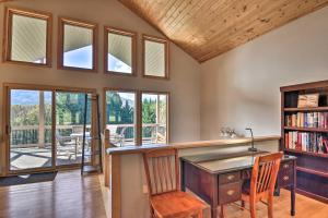 a home office with a desk and a book shelf at Tranquil 6-Acre Escape with Hot Tub and Mtn Views! in Swannanoa