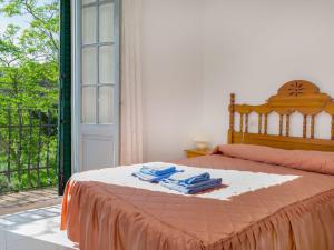 a bedroom with a bed with towels on it at Apartment La Rectoria by Interhome in La Vall de Santa Creu