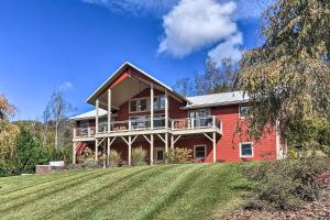 a large red house with a large lawn in front of it at Tranquil 6-Acre Escape with Hot Tub and Mtn Views! in Swannanoa