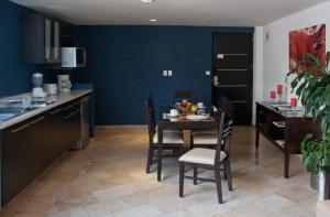 a kitchen and dining room with a table and chairs at Suites Berna 12 in Mexico City +13 photos
