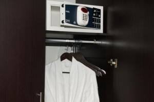 a robe hanging in a door with a microwave at Suites Berna 12 in Mexico City