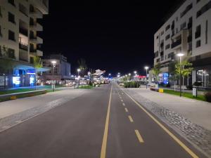 an empty city street at night with buildings at Apartament 4Tourists 2 in Braşov