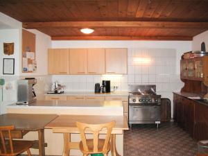 a kitchen with a stove and a table with chairs at Holiday Home Schwalbenhof by Interhome in Oberau +47 photos
