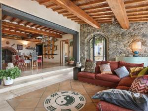 a living room with a red couch and a stone wall at Holiday Home Maestraccio by Interhome in Buti +25 photos
