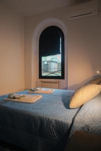 a bedroom with a large bed with a window at MAVI'S HOME in Chiari