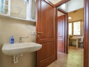 Łazienka z umywalką i drewnianymi drzwiami w obiekcie Apartment Capanna - CNG175 by Interhome w mieście Magnano