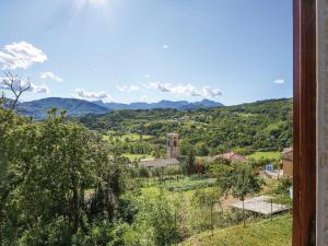 a view of a village with mountains in the background at Apartment Caminetto - CNG177 by Interhome in Magnano