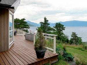 a wooden deck with a view of the water at Holiday Home Lyktvorholmen - FJS618 by Interhome in Hopperstad