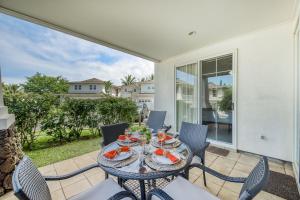 a patio with a table and chairs on a balcony at Plantations at Princeville #1312 in Princeville