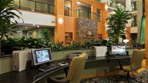an office with three computers on a desk with chairs at Holiday Inn Express & Suites Atlanta Southwest-Fairburn in Fairburn