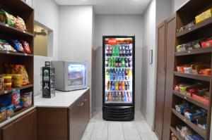 a grocery store aisle with a soda refrigerator in a store at Holiday Inn Express & Suites Batesville, an IHG Hotel in Batesville