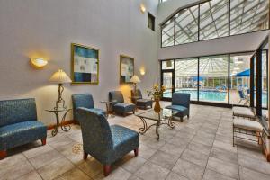 a waiting room with chairs and a pool at Holiday Inn Express Hotel & Suites - Belleville Area, an IHG Hotel in Belleville