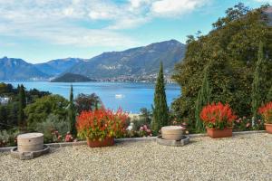 een uitzicht op een meer met bloemen in potten bij Agriturismo Il Colle in Bellagio