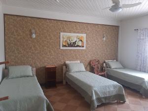 Un pat sau paturi într-o cameră la Pousada Recanto Feliz Itatiba