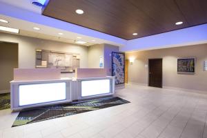 a lobby of a hospital with two large screens at Holiday Inn Express Hastings, an IHG Hotel in Hastings