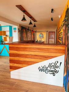 a restaurant with a counter with a welcome sign at In Di House of Reggae Boutique in San Andrés