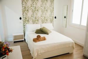 a teddy bear sitting on a bed in a bedroom at Parigi Hotel bed and Breakfast in Santa Cruz de Tenerife