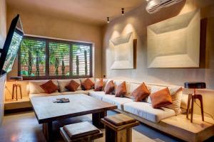a living room with a couch and a table at Privada Soliman Bay villa pets welcome! in Tulum