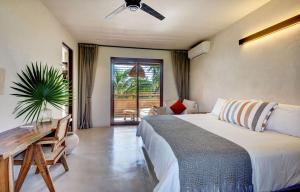 a bedroom with a bed and a desk and a window at Privada Soliman Bay villa pets welcome! in Tulum +28 photos