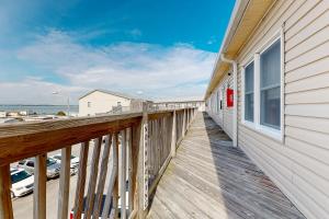 a balcony with a view of the ocean at Bayspot L in Ocean City