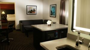 a hotel room with a sink and a living room at Holiday Inn Express Hollywood Walk of Fame by IHG in Los Angeles