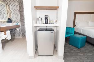 a hotel room with a refrigerator and a bed at Holiday Inn Express Hollywood Walk of Fame by IHG in Los Angeles