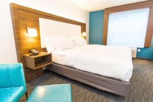 a hotel room with a bed and a chair at Holiday Inn Express Hollywood Walk of Fame by IHG in Los Angeles