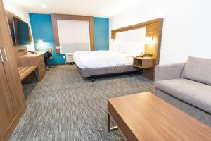 a hotel room with a bed and a couch at Holiday Inn Express Hollywood Walk of Fame by IHG in Los Angeles