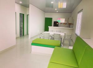 a room with a green and white table and chairs at Bahia Tropical Sandia Kiwi Piña in Coveñas +31 photos