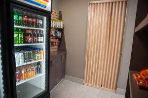 a refrigerator filled with lots of drinks in a room at Holiday Inn Express Hotel & Suites Norfolk, an IHG Hotel in Norfolk