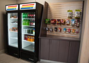 a refrigerator with drinks and drinks in a room at Holiday Inn Express Hotel & Suites Norfolk, an IHG Hotel in Norfolk