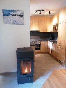 a kitchen with a stove in the middle of a room at Alpen-Appartement Auerhof in Volders