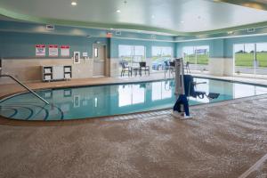 a swimming pool with a person in the middle of it at Holiday Inn Express & Suites - Bourbonnais East - Bradley by IHG in Bourbonnais