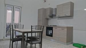 a kitchen with a table and chairs in a room at La casa del Belvedere in Grassano