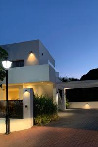 a white house with a street light in front of it at Casa Bodhi Boutique Hotel & Spa in Marbella