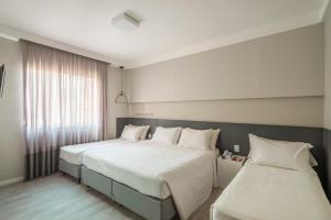 Postel nebo postele na pokoji v ubytování Hotel Melo