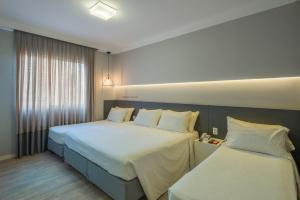 Postel nebo postele na pokoji v ubytování Hotel Melo
