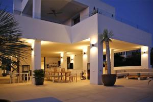 a house with a palm tree in front of it at Casa Bodhi Boutique Hotel & Spa in Marbella