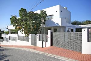 a white fence in front of a house at Casa Bodhi Boutique Hotel & Spa in Marbella