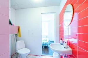 a bathroom with a sink and a toilet and a mirror at Mereranna apartment 5 in Kuressaare