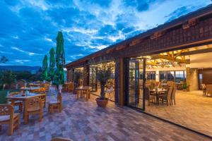 a patio at a restaurant with tables and chairs at Etno selo Azbuka in TrÅ¡iÄ‡