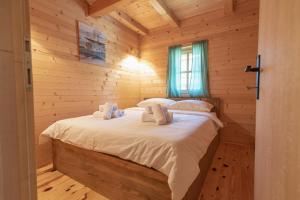 a bedroom with a bed in a log cabin at Etno selo Azbuka in TrÅ¡iÄ‡ +96 photos