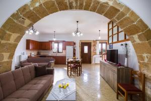 a living room with an archway and a living room at Antheon - Three Bedroom Villa with Private Pool in Áno Valsamóneron